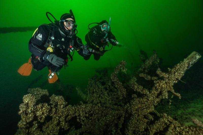 A technical diving instructor supervising training in cold water