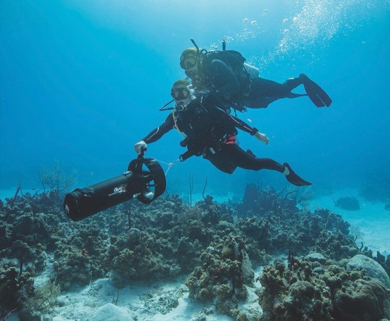 A diver using a diver propulsion vehicle underwater