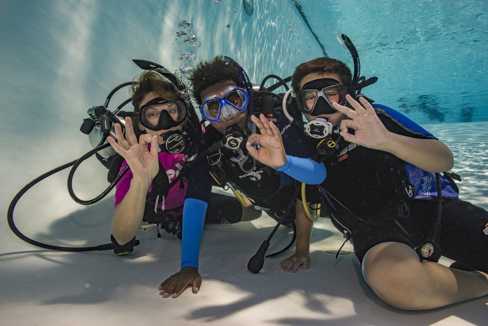 Children learning to scuba dive in the pool