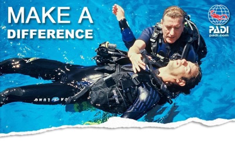Divers practising a rescue tow on the surface