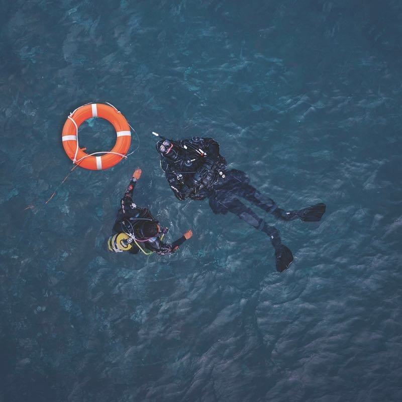 Divers practising rescue skills at the surface
